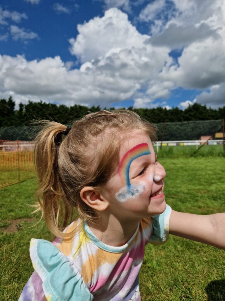 Child with rainbow facepaint
