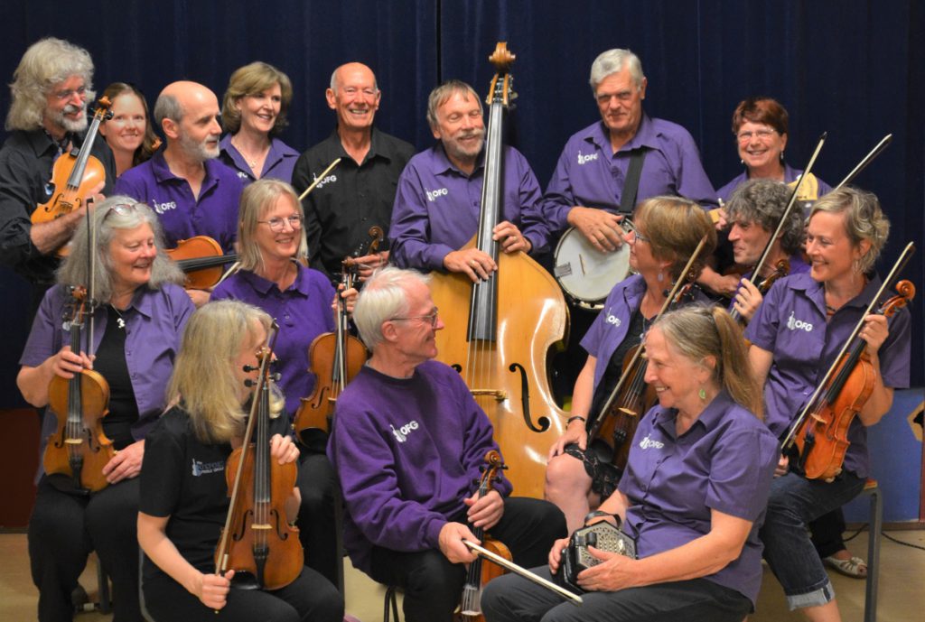 Image shows members of a fiddle group and their instruments