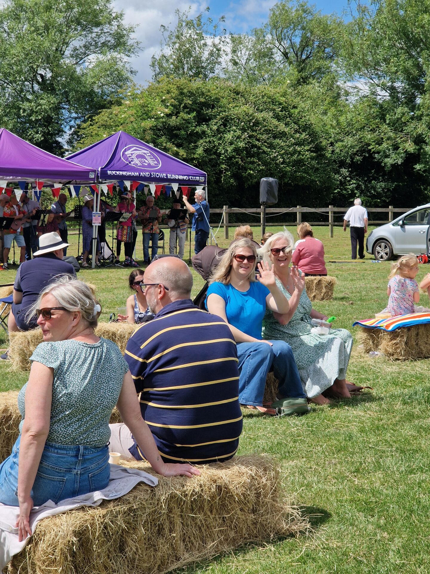 people sat on straw bales